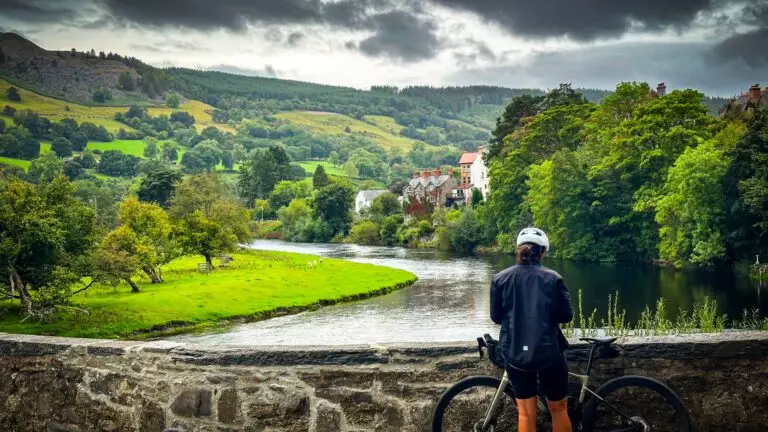 Cyclist on a stone bridge over a river in Wales